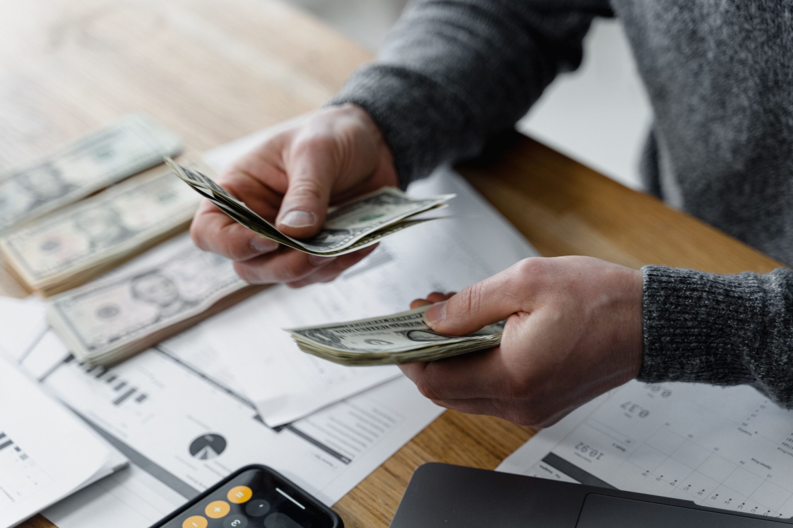 counting dollar bills on a desk